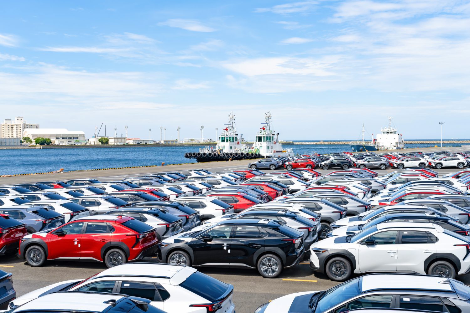 Major automakers are deliberately leaving newly imported vehicles at U.S. ports to delay paying steep tariffs, jamming shipping logistics.