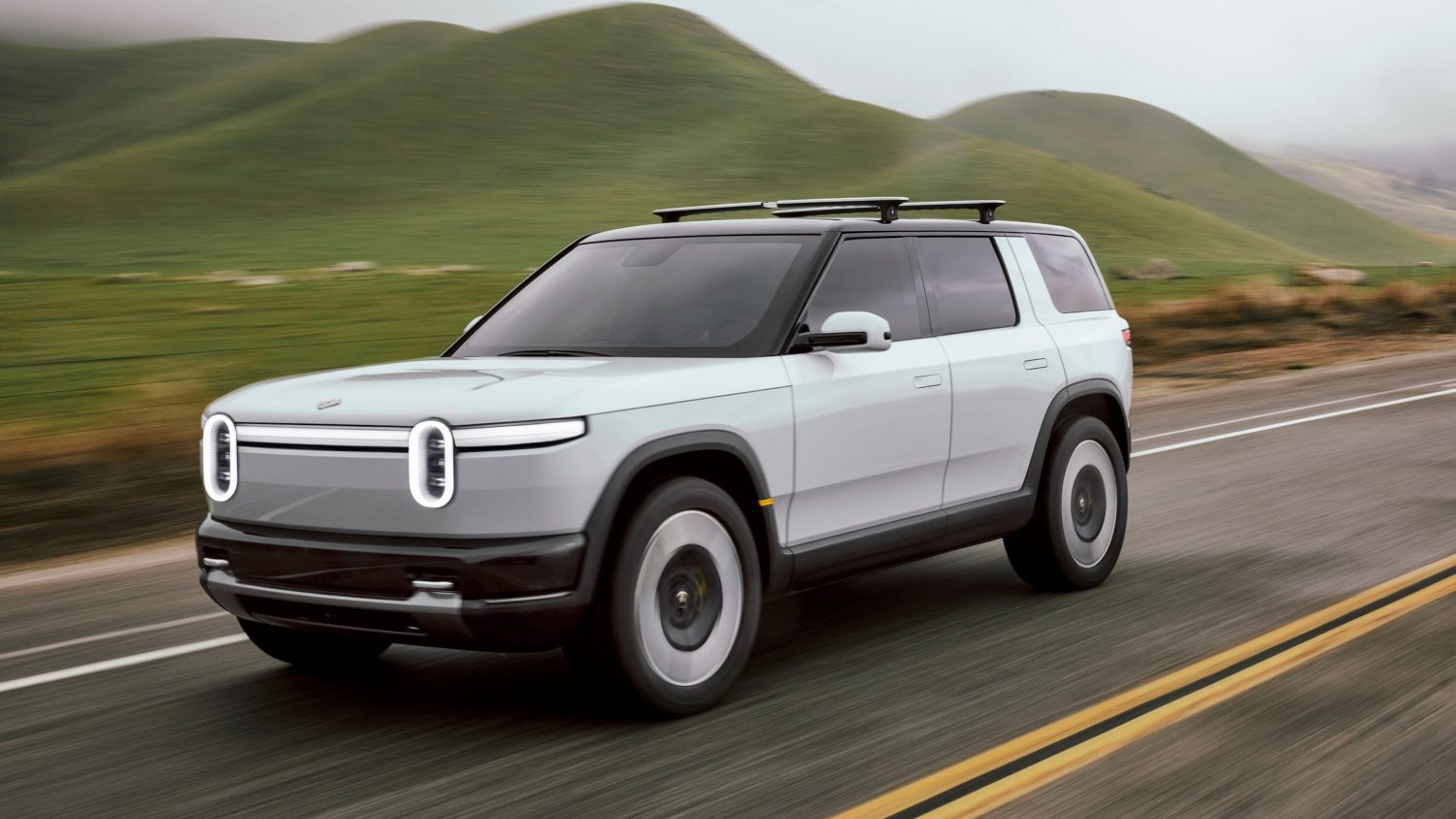 Rivian will redesign rear doors on its R2 SUV to improve manual release visibility and meet safety standards before 2026 deliveries.