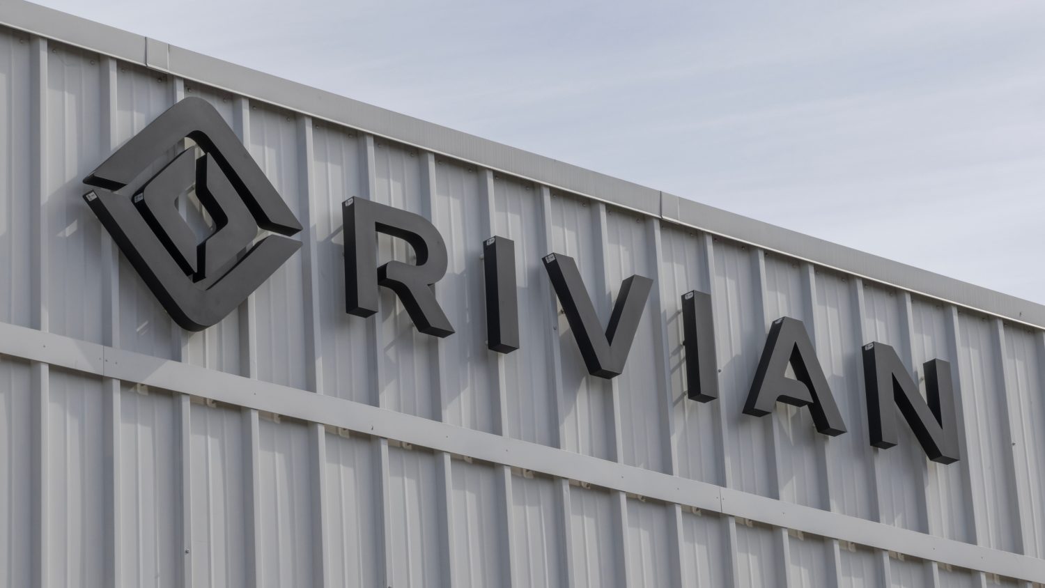 Rivian settles a $250 million IPO fraud lawsuit as it cuts jobs and refocuses on its R2 SUV launch amid slowing EV demand.
